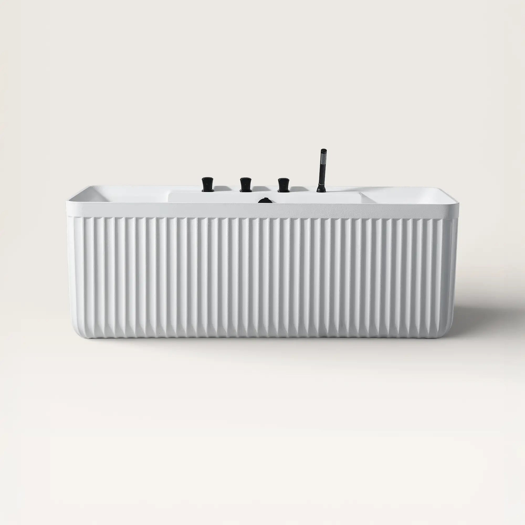 Front view of the Kolpa back-to wall bath with black tapware in white
