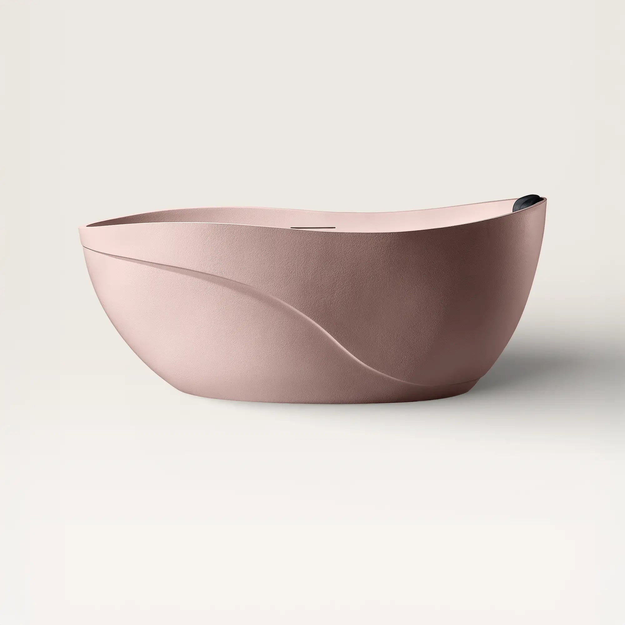 Front view of the Soma freestanding bath in pink with a black magnetic pillow