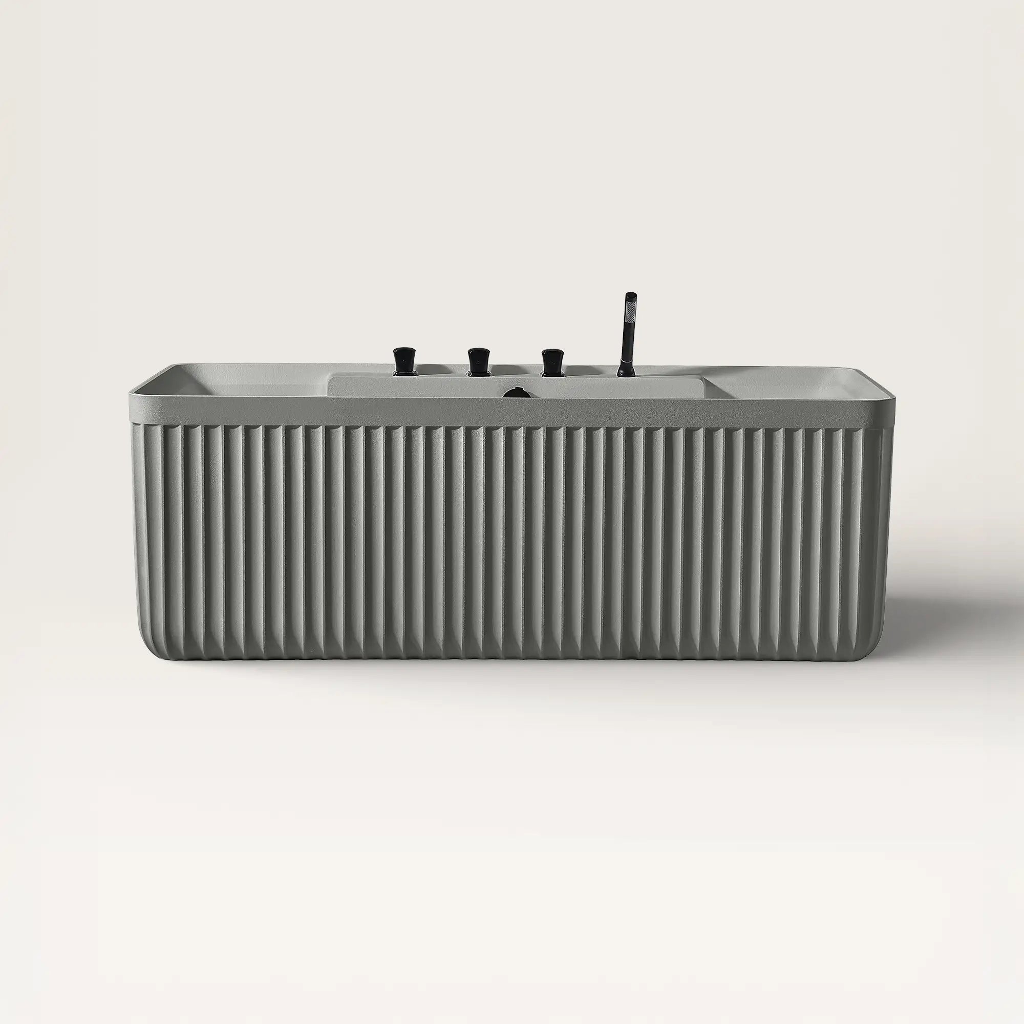 Front view of the Kolpa back-to wall bath with black tapware in cement grey