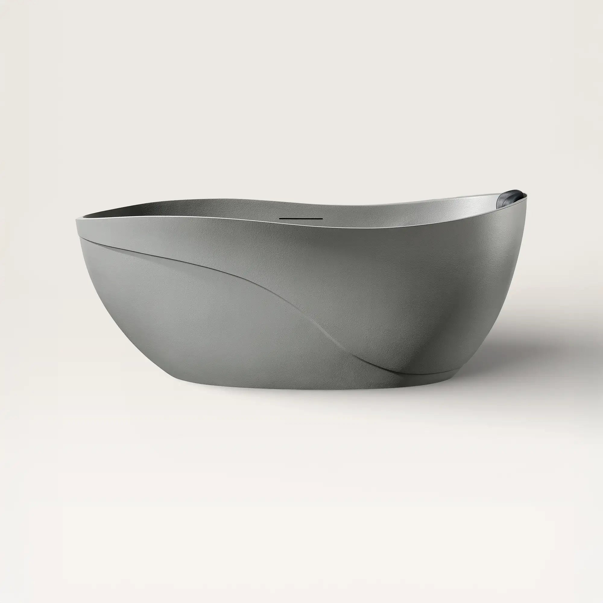 Front view of the Soma freestanding bath in cement-grey with a black magnetic pillow