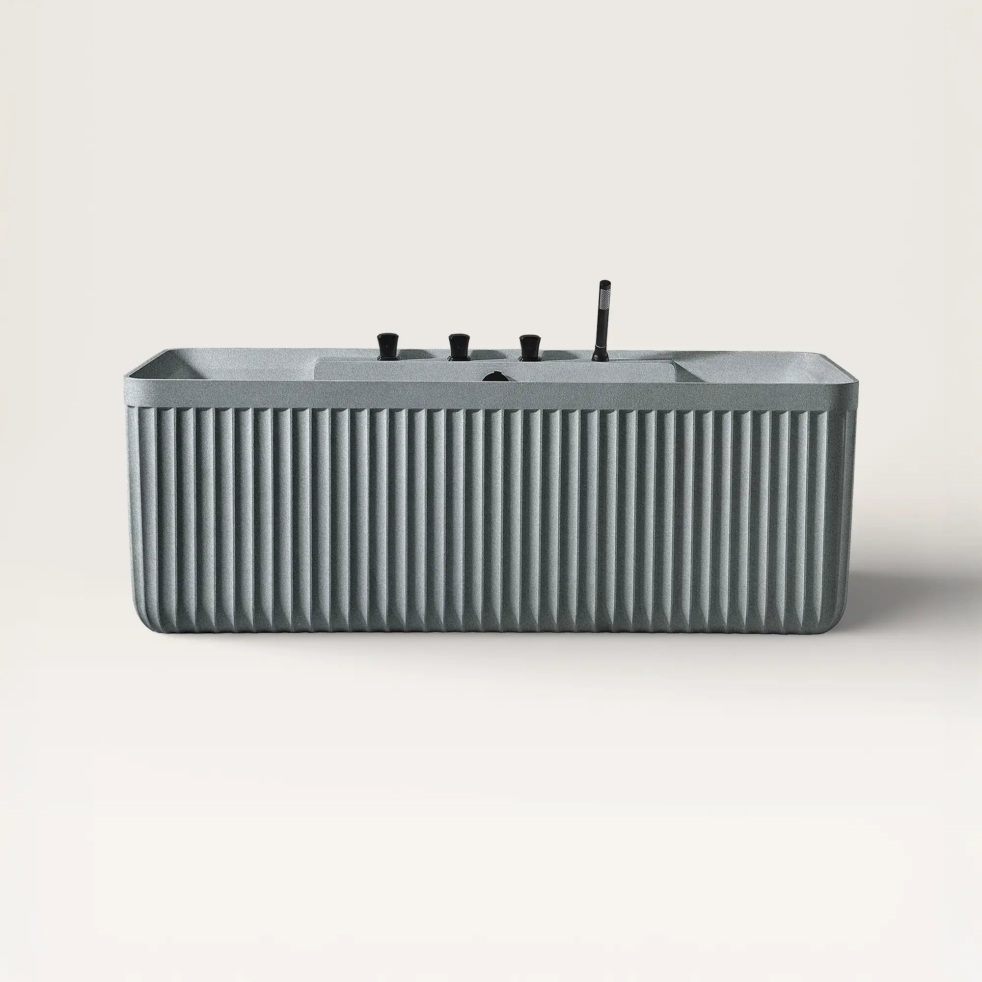 Front view of the Kolpa back-to wall bath with black tapware in granite grey