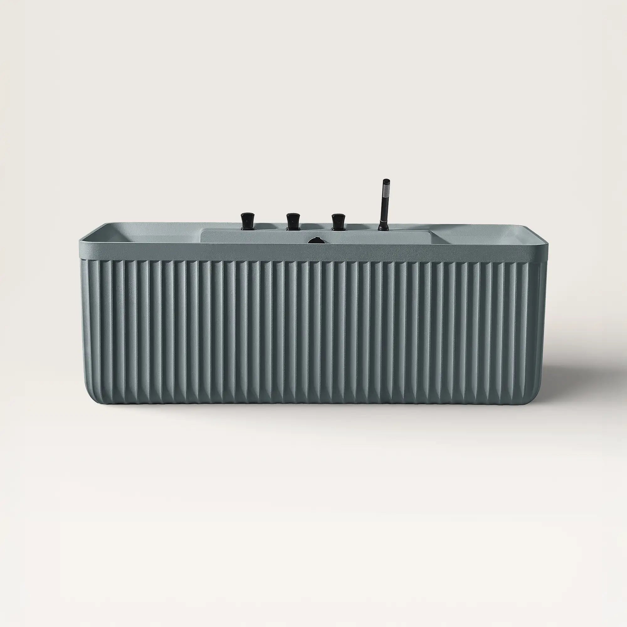 Front view of the Kolpa back-to wall bath with black tapware in blue-grey