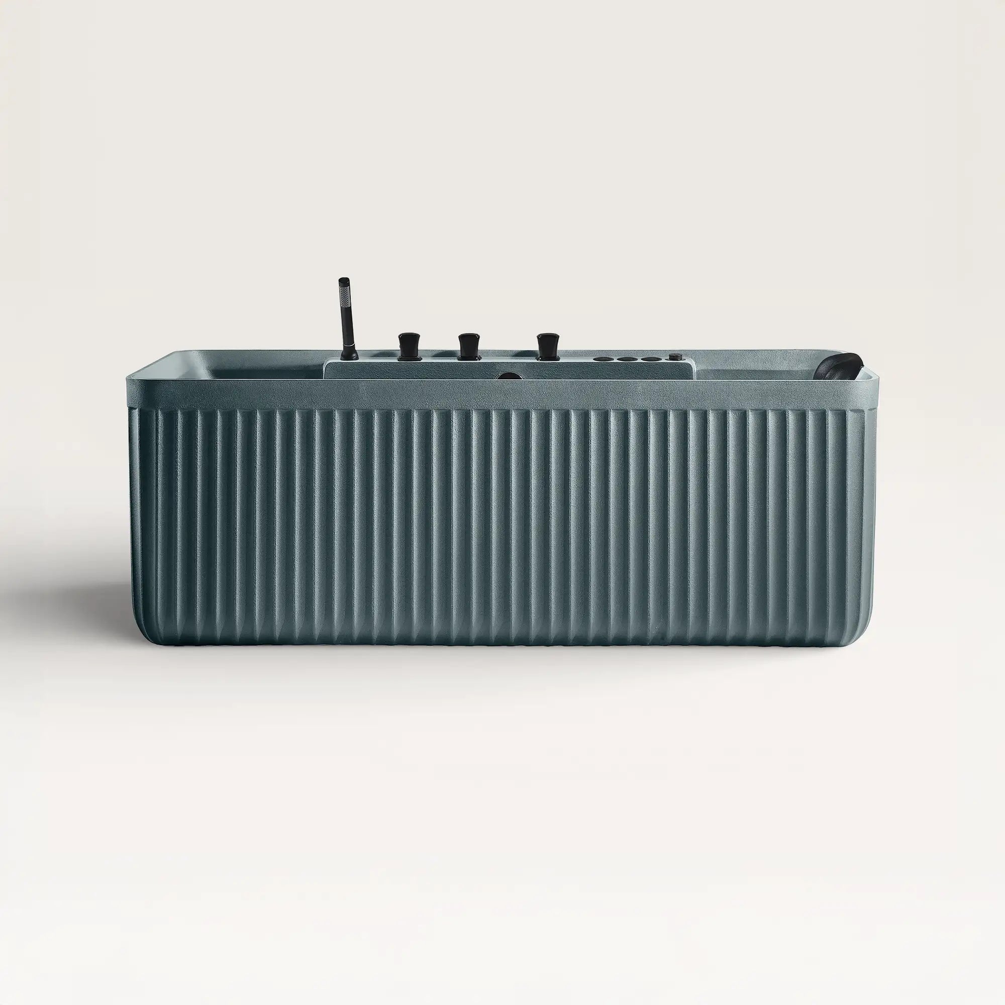 Front view of the Kolpa Spa bath with black tapware in blue-grey