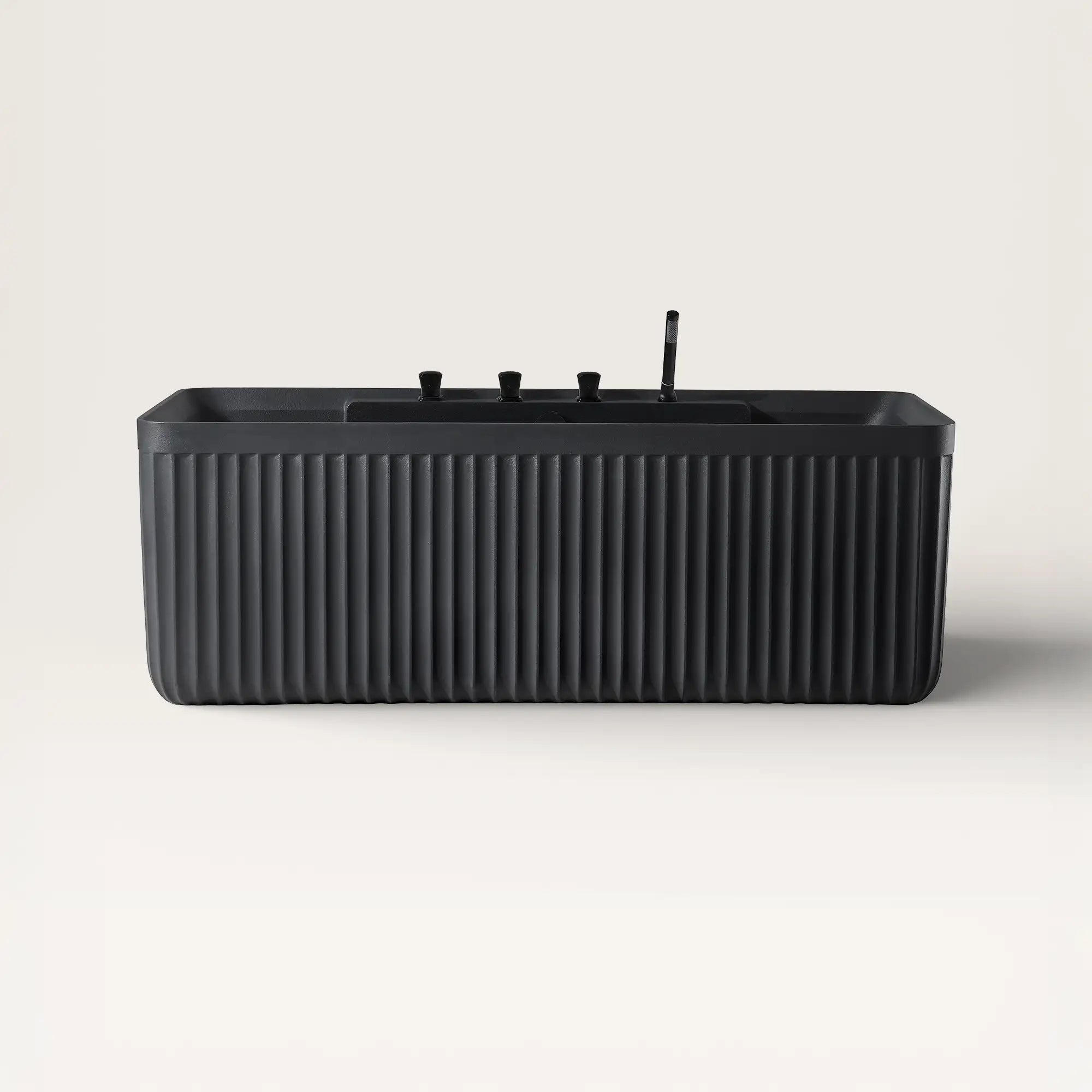 Front view of the Kolpa back-to wall bath with black tapware in black