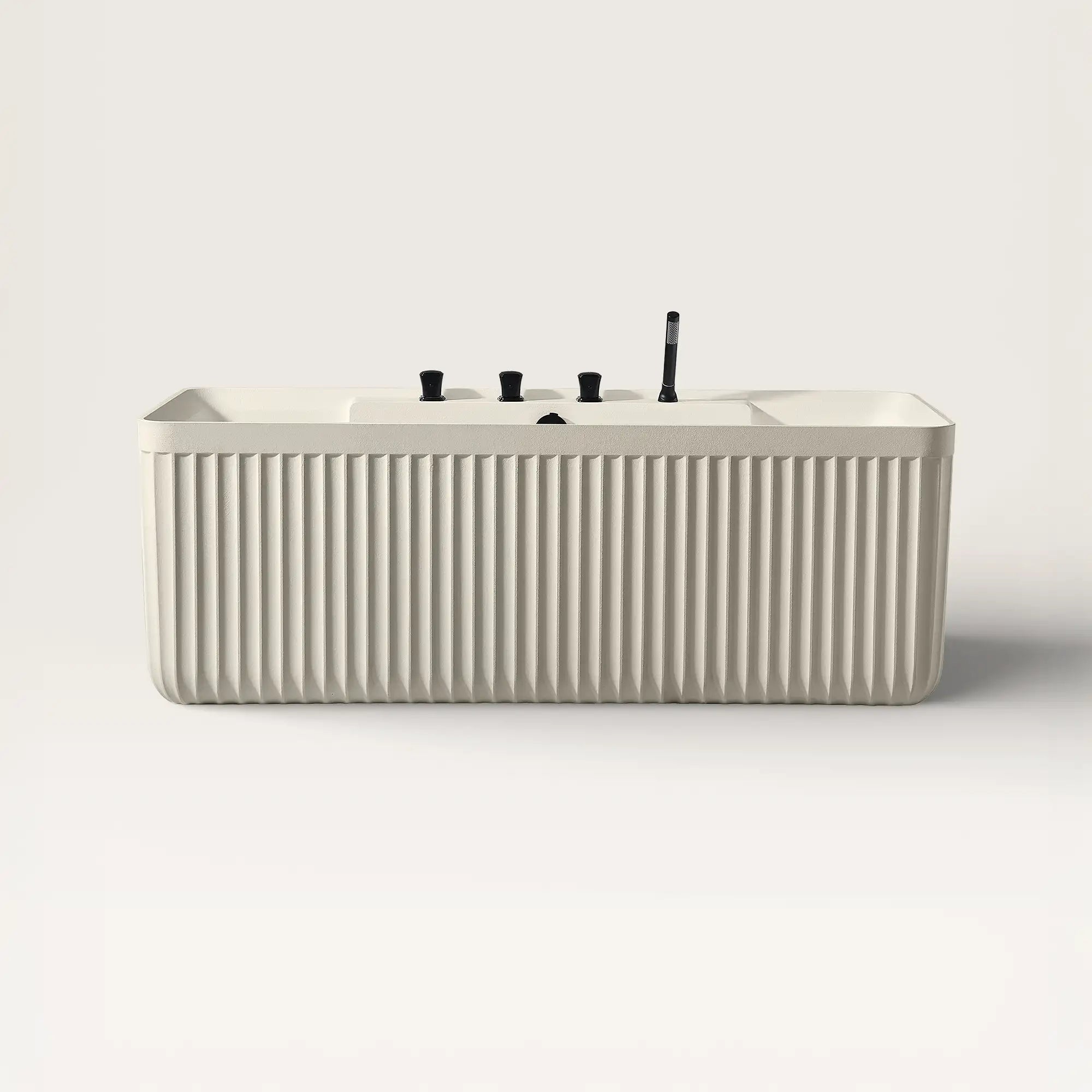 Front view of the Kolpa back-to wall bath with black tapware in cream