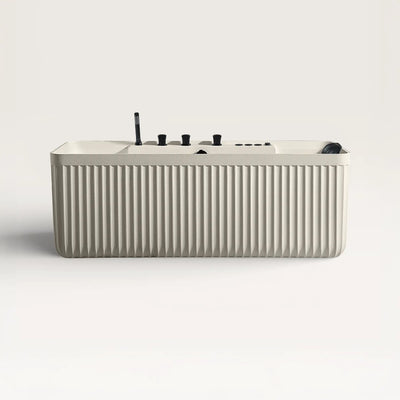Front view of the Kolpa Spa bath with black tapware in cream