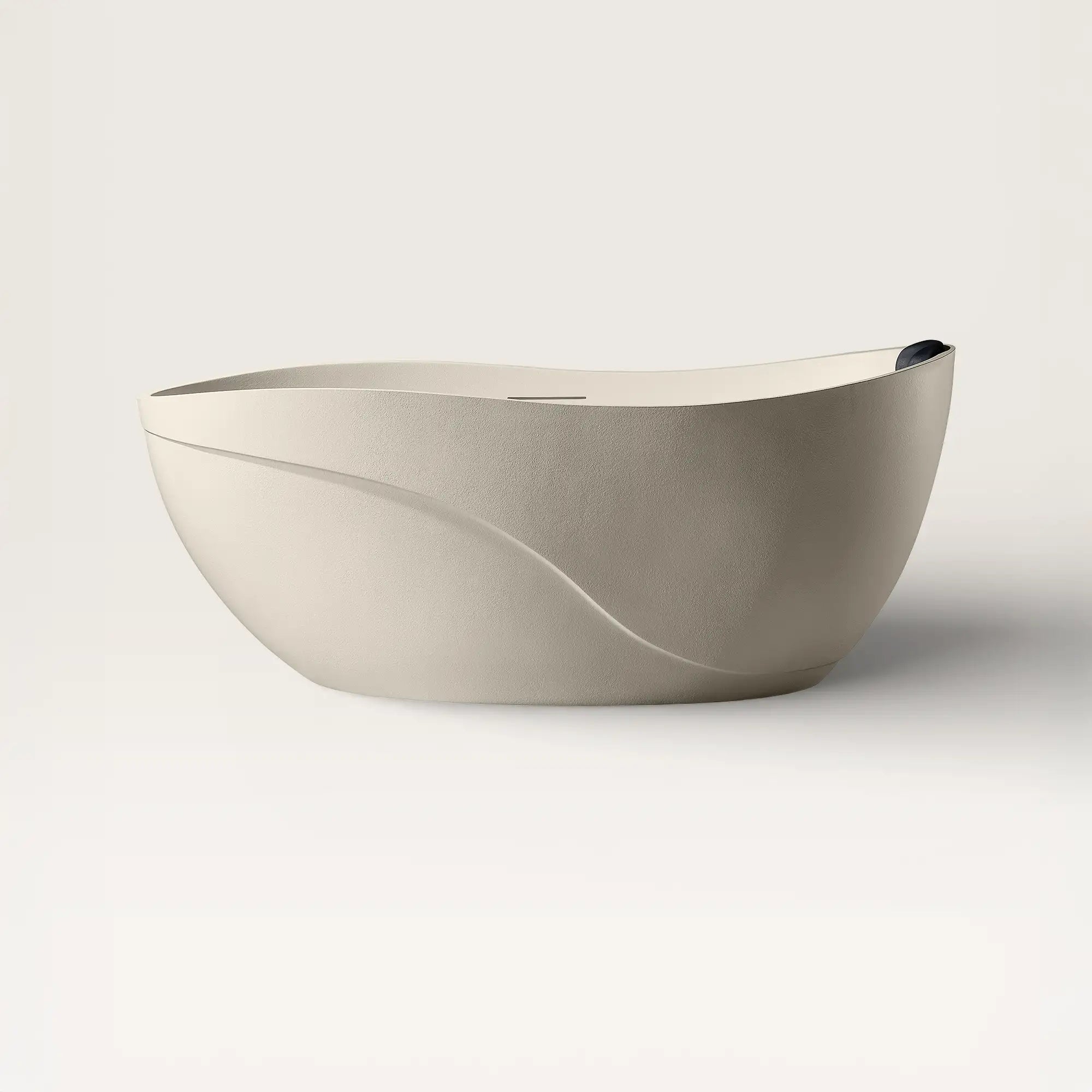 Front view of the Soma freestanding bath in cream with a black magnetic pillow