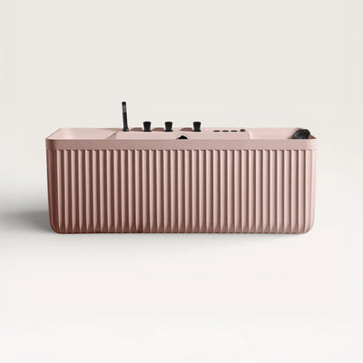 Front view of the Kolpa Spa bath with black tapware in pink