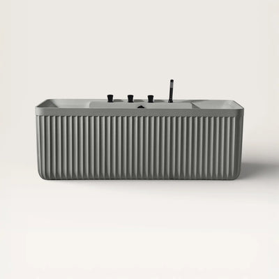 Front view of the Kolpa back-to wall bath with black tapware in cement grey