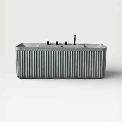 Front view of the Kolpa back-to wall bath with black tapware in granite grey