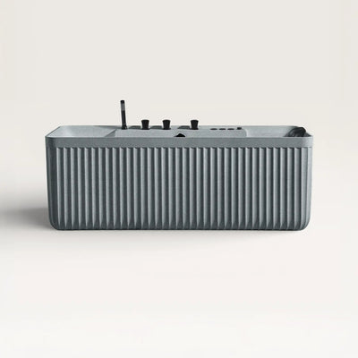 Front view of the Kolpa Spa bath with black tapware in granite-grey