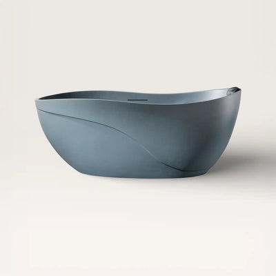 Front view of the Soma freestanding bath in blue-grey with a black magnetic pillow