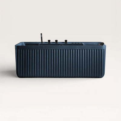 Front view of the Kolpa Spa bath with black tapware in prussian blue