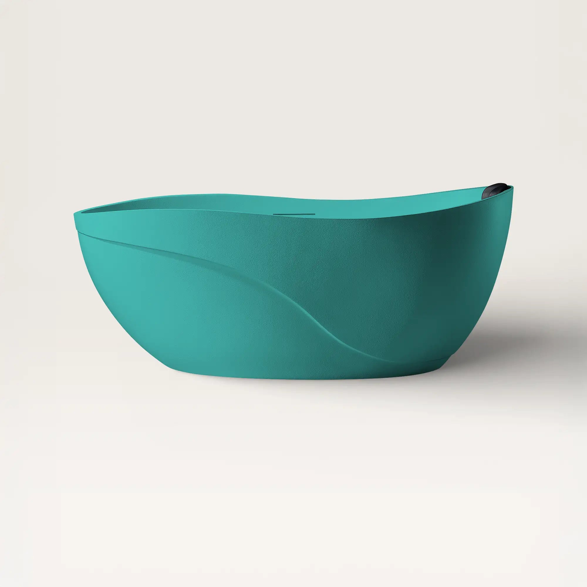Front view of the Soma freestanding bath in celadon blue with a black magnetic pillow