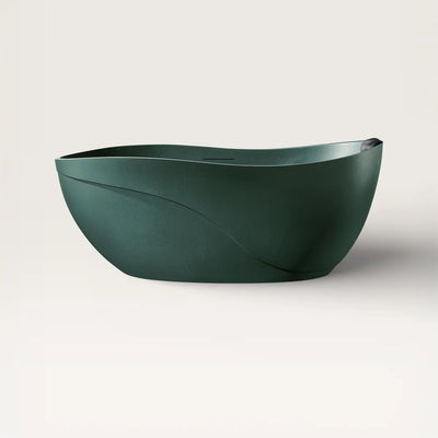 Front view of the Soma freestanding bath in green with a black magnetic pillow