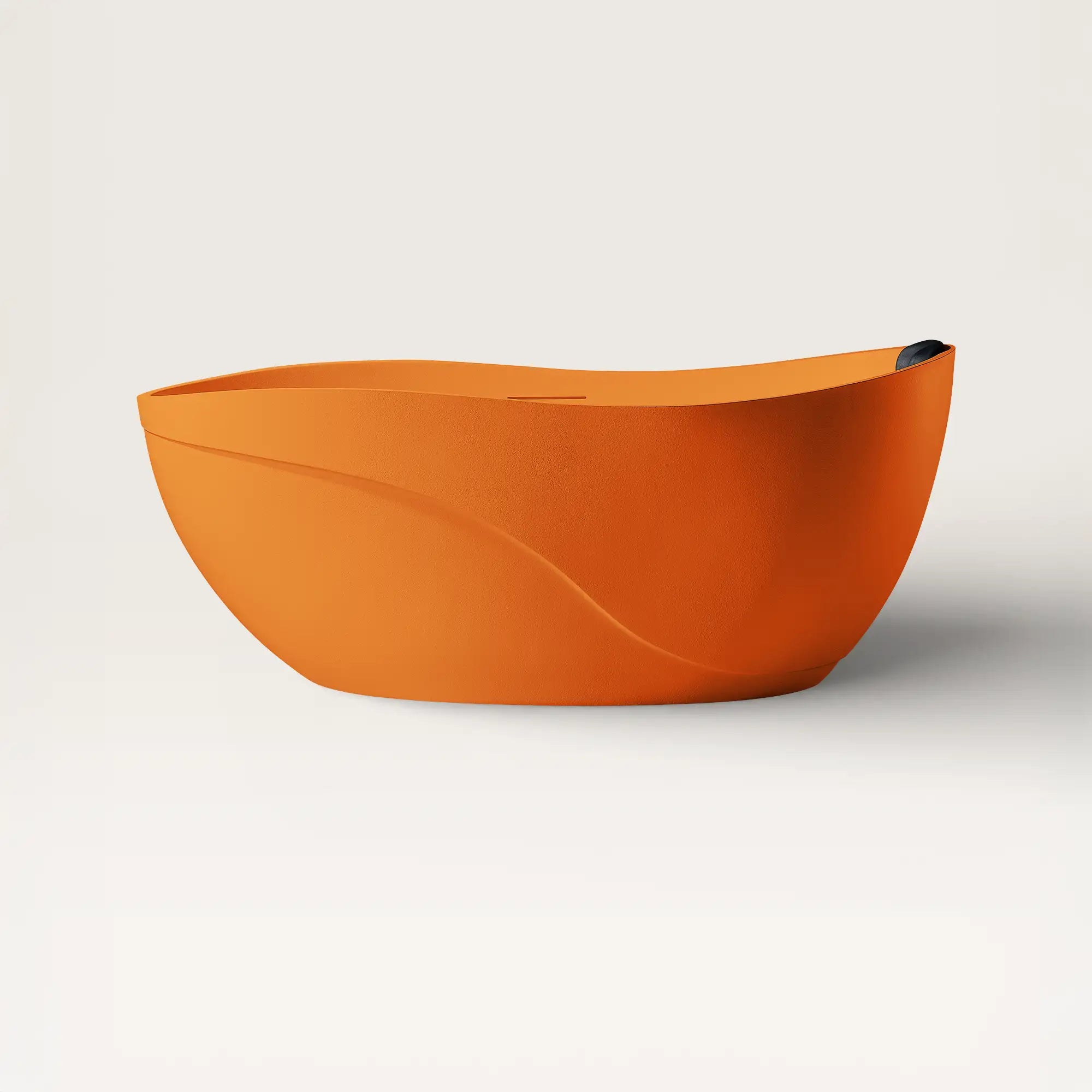 Front view of the Soma freestanding bath in orange with a black magnetic pillow