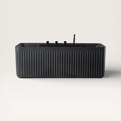 Front view of the Kolpa back-to wall bath with black tapware in black