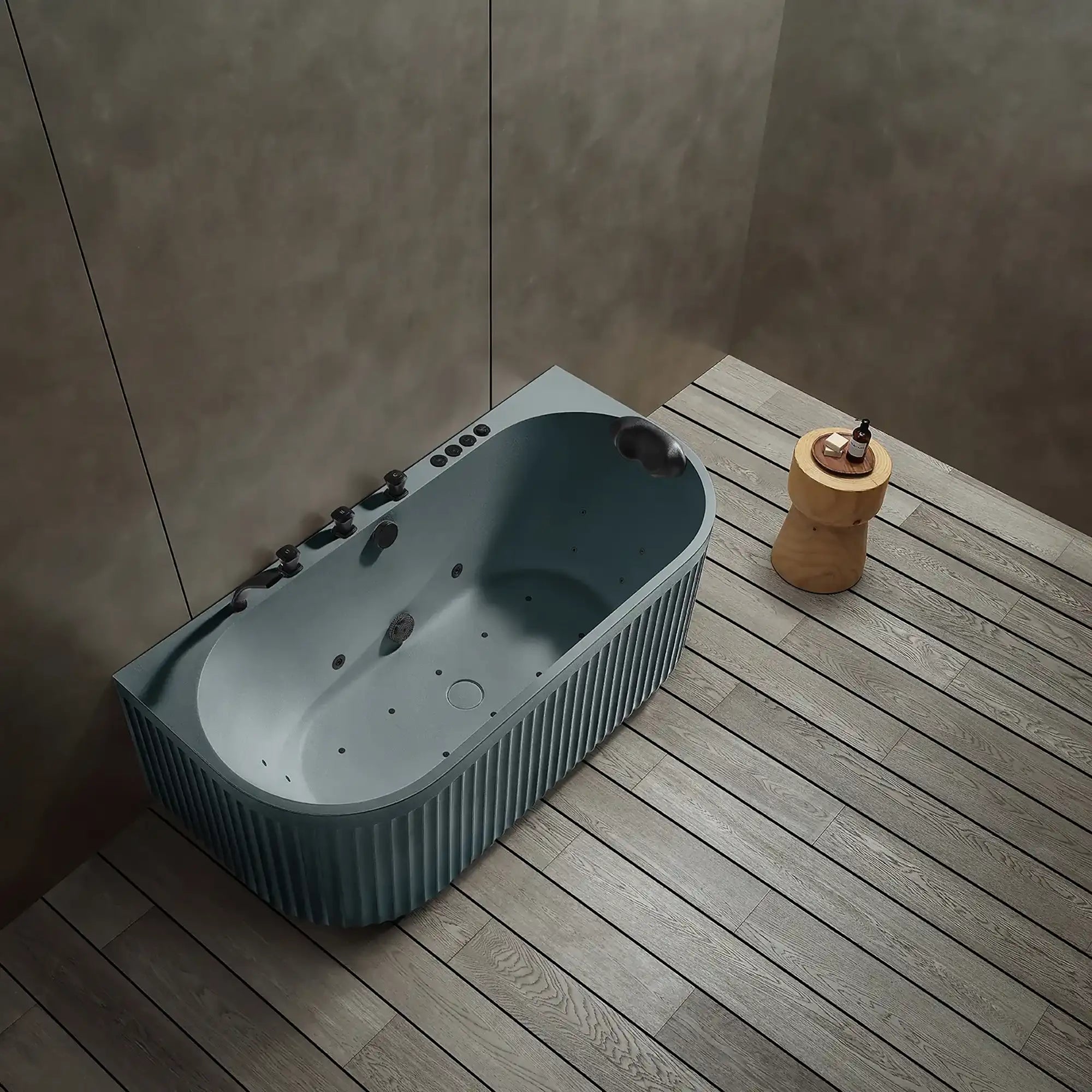 A top view of the Doria spa bathtub in blue grey with black tapware, in a modern bathroom with wooden floor and gray walls.