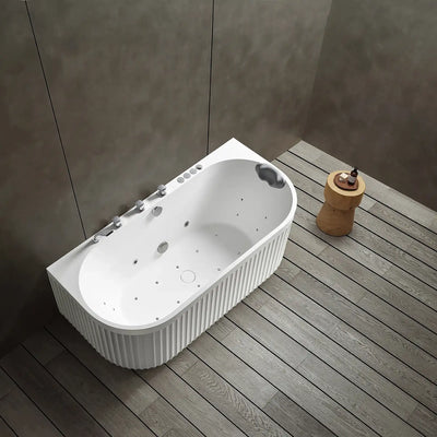 A top view of the Doria back-to-wall with faucet bathtub in white with silver tapware, in a modern bathroom with wooden floor and gray walls.