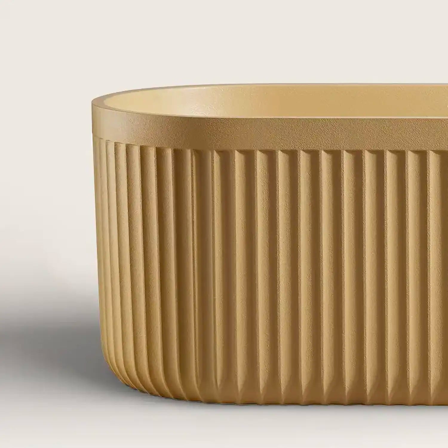 Close up of the pop-up waste of a Doria freestanding bath in caramel colour, showing the disctinct texture of the material