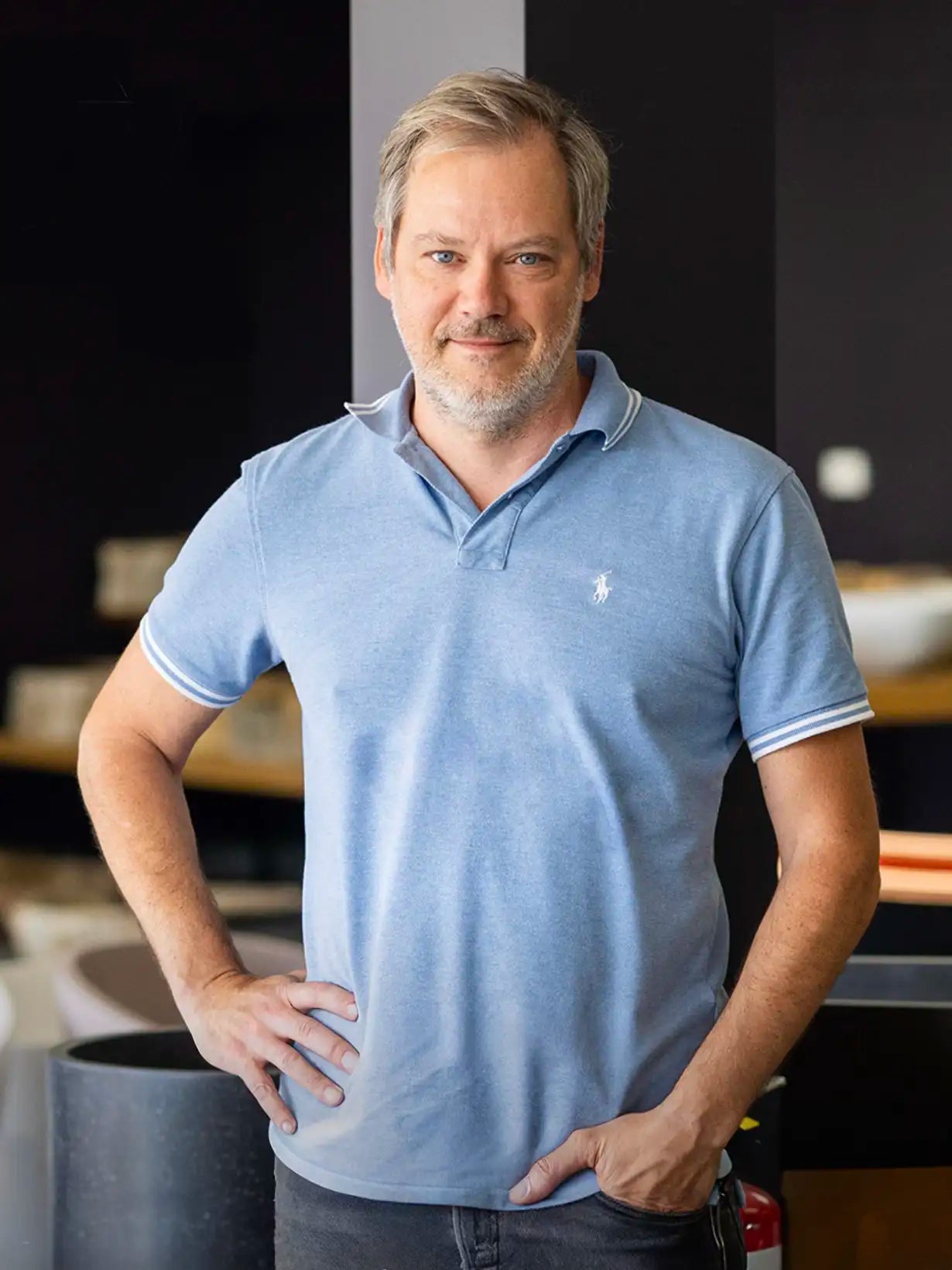 A portrait of Vincent, the founder and owner of Bellastone, wearing a blue polo shirt and jeans.